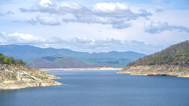 Time laps the boat runs on the water above the dam,
sky on mountain,Bhumibol Dam,Tak, Thailand