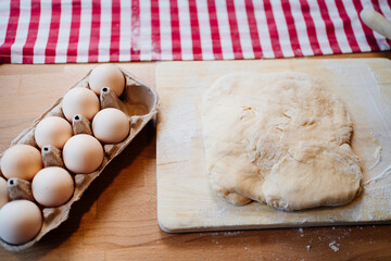 tray with eggs and dough on a wooden table. ingredients for baking. Recipes.