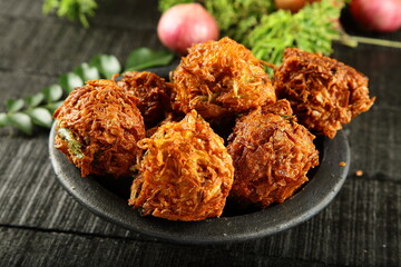 Homemade spicy fried Indian vegetarian snack - ulli vada, onion fritters, Pyaaz Pakoda .