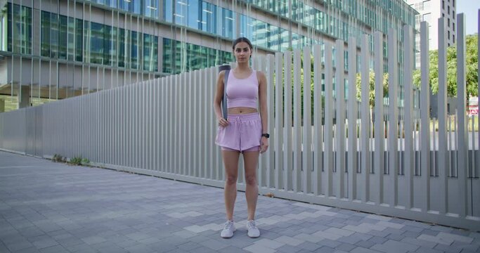 Woman spends weekend actively stands in full length works hard eagers to be fitter and better at sport has workout with modifications for different levels planned timetable. Covid reopening gyms