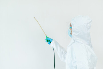 Sanitary staff sanitizing a surface inside the building cause coronavirus or COVID-19 disease pandemic.
