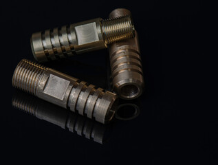 brass threaded fittings or high pressure polymer pipe. for plumbing pipeline. Isolated on Black background.