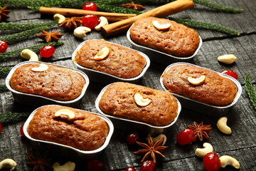 Homemade red plum cup cakes, muffins on a rustic wooden kitchen table background.