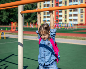 An elementary school student plays on the school playground.