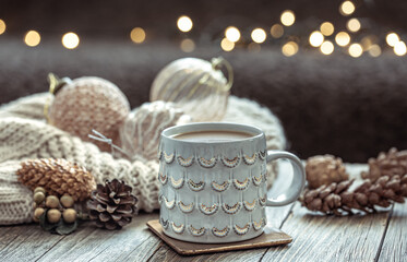 Obraz na płótnie Canvas Cozy Christmas composition with a cup and festive decor details.