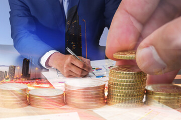 double exposure of Euro Coin stacks on table, businessman review charts, light trails on the street and urban in the night as business, investment,currency and exchange rate concept