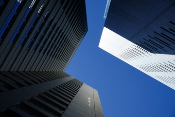 Obraz na płótnie Canvas Futuristic tall buildings with blue sky and sunshine3