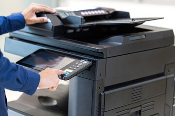 Businessman press button on panel of printer photocopier  network , Working on photocopies in the...