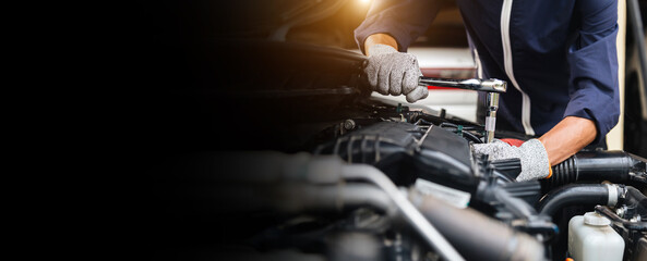 Automobile mechanic repairman hands repairing a car engine automotive workshop with a wrench, car...