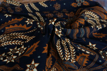 A traditional Indonesian fabric, namely batik cloth which has unique and different patterns and image motifs for each region and is rolled up to form flowers. Cultural theme photos, typical of Asia