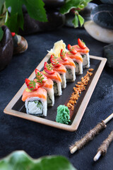 Rolls Philadelphia with smoked salmon. Traditional Japanese cuisine. Rolls with cucumber, Philadelphia cheese and smoked salmon. Healthy food. Restaurant menu concept. Vertical photo.