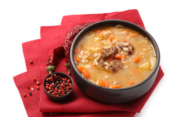 Bowl with tasty beef barley soup on white background