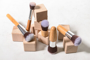 Fototapeta na wymiar Set of makeup brushes with decor on white background