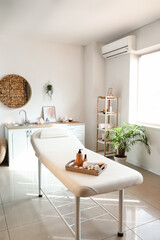 Tray with beautiful spa composition on couch in salon