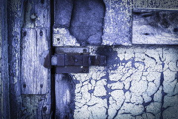 rusty lock on a texture of old, wooden, purple, door, which the old paint flaking