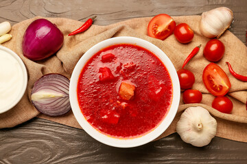 Composition with tasty borscht on wooden background