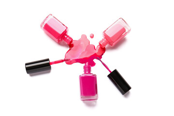 Bottles of nail polishes with brushes and blot on white background