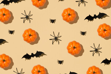 Happy Halloween concept. Overhead close up view photo of pattern of orange funny pumpkin spiders...