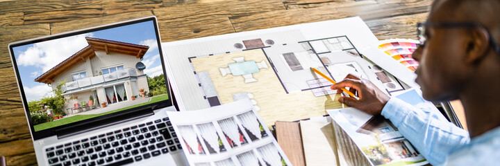 Real Estate Designer Working On Computer