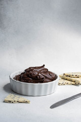 Cocoa spread food photo. Brown chocolate paste with white chocolate pieces on white background.