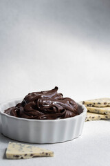 Cocoa spread food photo. Brown chocolate paste with white chocolate pieces on white background.
