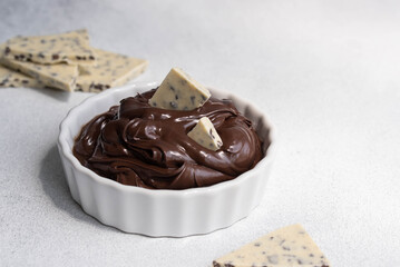 Cocoa spread food photo. Brown chocolate paste with white chocolate pieces on white background.