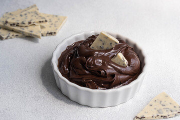 Cocoa spread food photo. Brown chocolate paste with white chocolate pieces on white background.