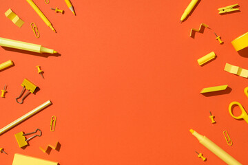 Top view photo of yellow stationery school supplies scissors pencils markers binder clips pushpins...