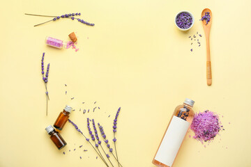 Composition with bottles of lavender essential oil, sea salt and flowers on color background