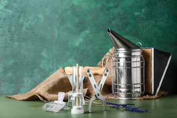 Beekeeping supplies on color background