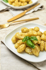 Plates with tasty pesto gnocchi on table