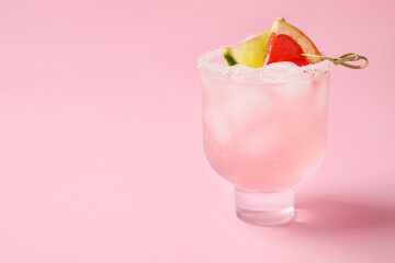 Glass of tasty grapefruit margarita on color background