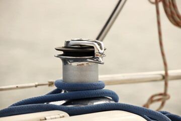 A winch on a sailing yacht for pulling up files and sheets against the background of the summer...