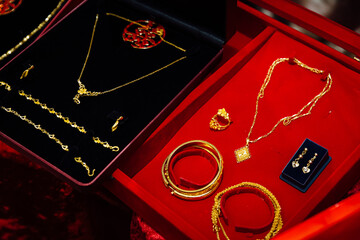 Gold jewelry presented to the couple in a red box in Asian wedding customs