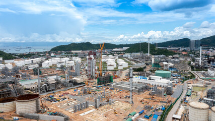 Chemical oil refinery plant, power plant on blue sky , industrial area near the sea.