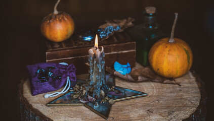 Candle burns on the altar, magic among candles, clean energy, magical concept, autumn time	