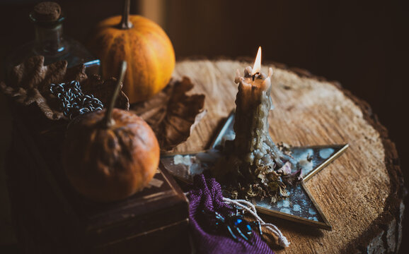 Candle burns on the altar, magic among candles, clean energy, magical concept, autumn time	