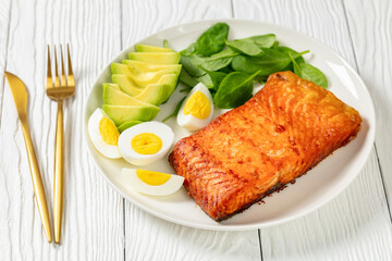 baked salmon fillet with eggs , spinach, avocado