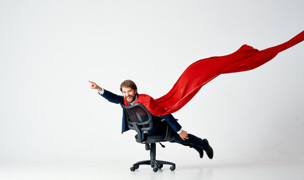 business man in suit office chair red cloak superhero