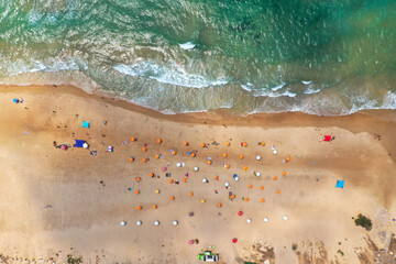 Mediterranean Beach with Yellow umbrellas, Aerial view.