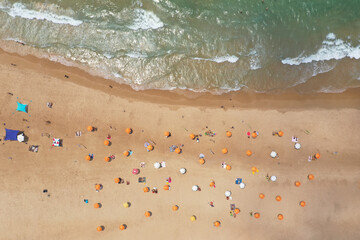 Mediterranean Beach with Yellow umbrellas, Aerial view.