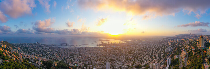 Haifa, Aerial panorama at sunrise, showing the city bay houses and commercial Port.