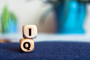 IQ word concept on wooden cube. Intelligence symbol. Brain or talent concept. Copy space, blur...