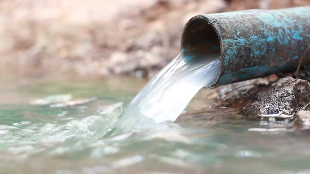 sewage from the sewer pollutes a lake, top view, slow motion