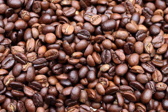 Roasted coffee beans background. Beverage concept for wallpaper, backdrop and texture.