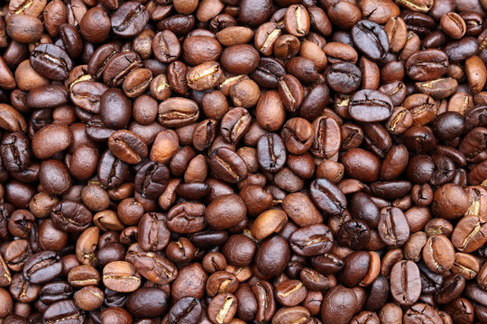 Roasted coffee beans background. Beverage concept for wallpaper, backdrop and texture.
