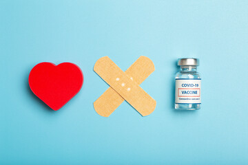 Vaccination concept. Ampoule of covid-19 coronavirus vaccine on blue medical minimal background.