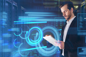 Businessman wearing formal suit is touching tablet with hologram