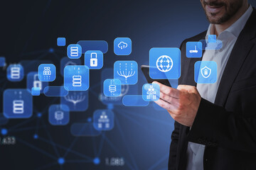 Businessman wearing formal suit is holding smartphone with digital interface