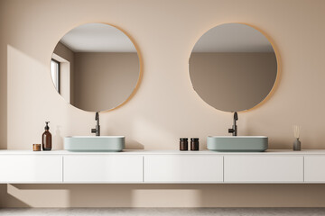 Beige bathroom wall with round mirrors and a double shelf vanity
